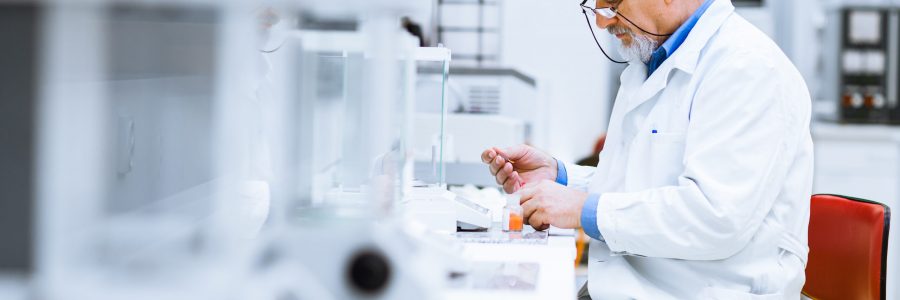 Senior male researcher carrying out scientific research in a lab (shallow DOF; color toned image)